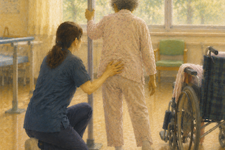 Caregiver guiding an elderly woman with a walker in a bright room, wheelchair nearby in a care setting.